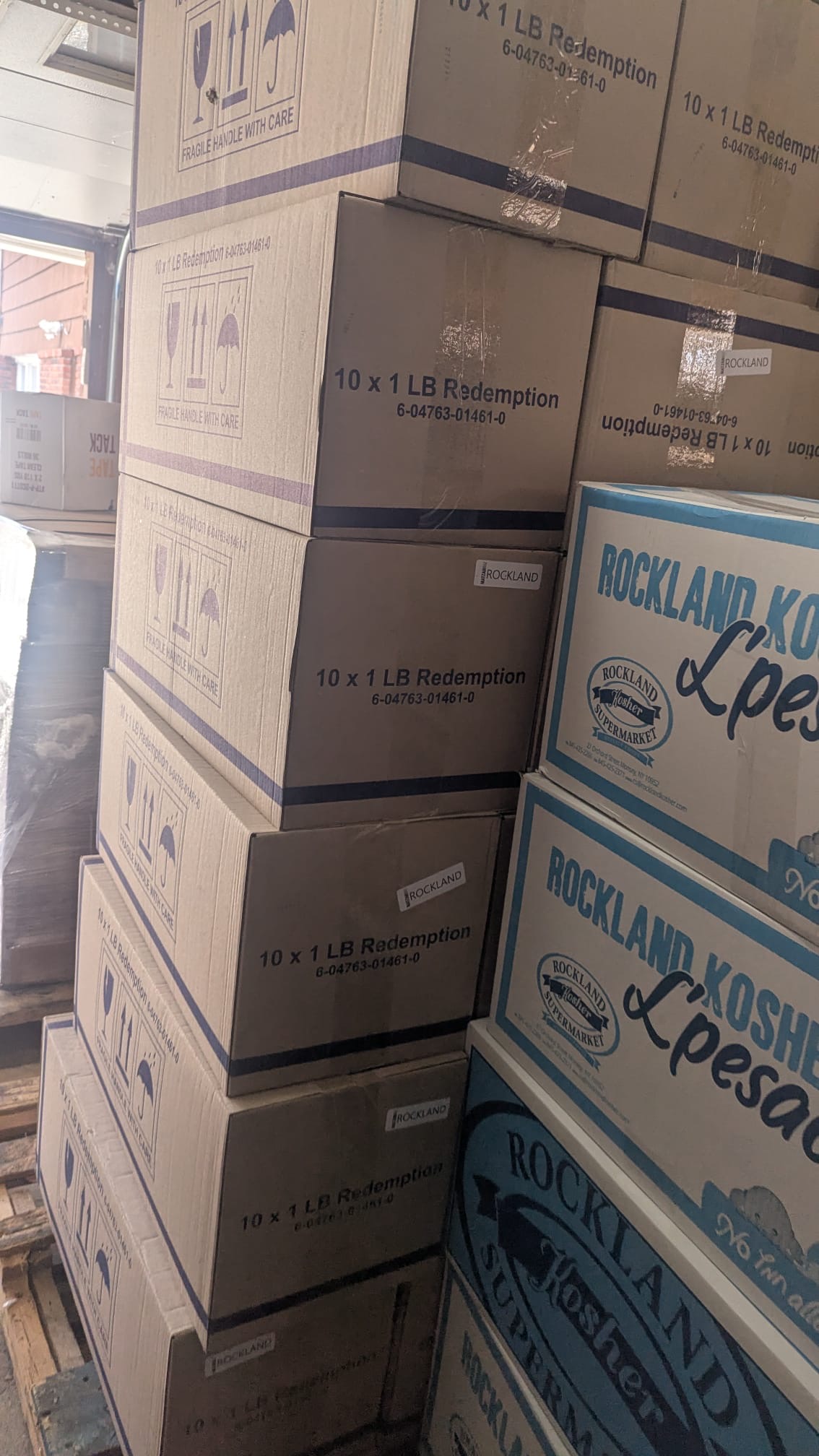 Pallets stacked high with boxes of Shmurah Matzah ready for distribution
